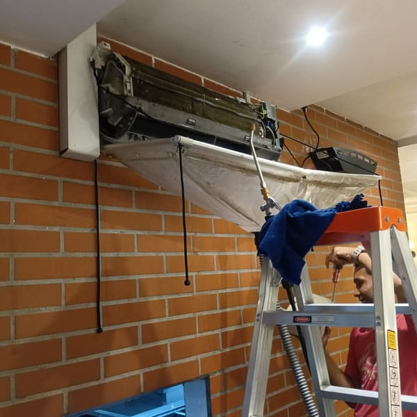 Technician servicing an air conditioner